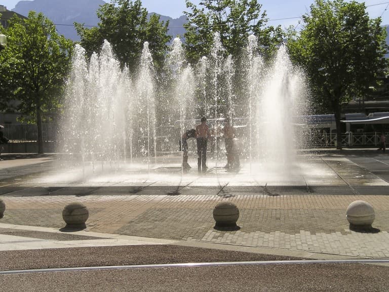 Youth took advantage of the beautiful spring days to play and bathe in the fountain in Grenoble, France