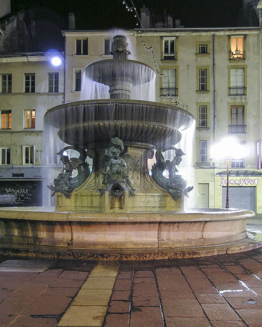 Fountain by night at the “Grenette” square in Grenoble, France