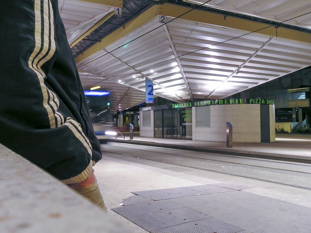 Tram arriving at the “Grand’Place” tram stop by night in Grenoble, France