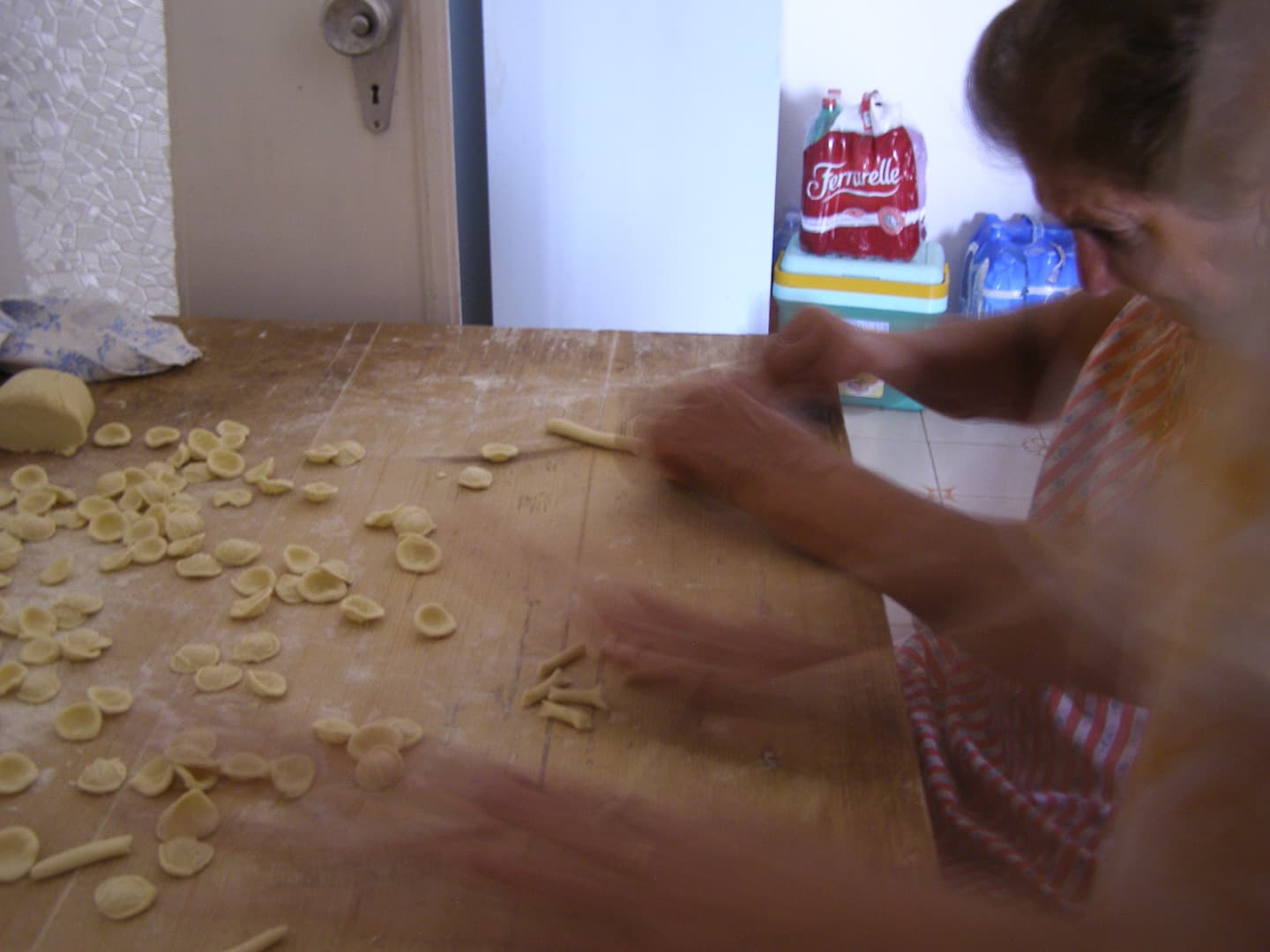 Old ladies are making hand-made pasta.