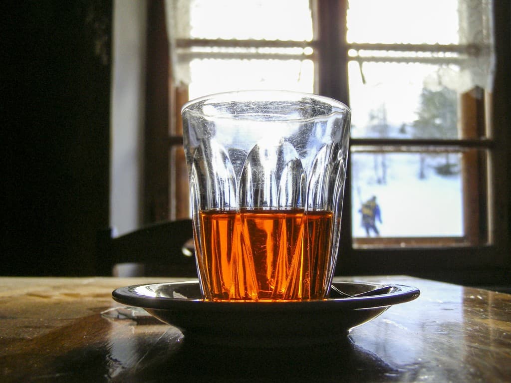 A glass with Punsch liquor on the table of the refuge